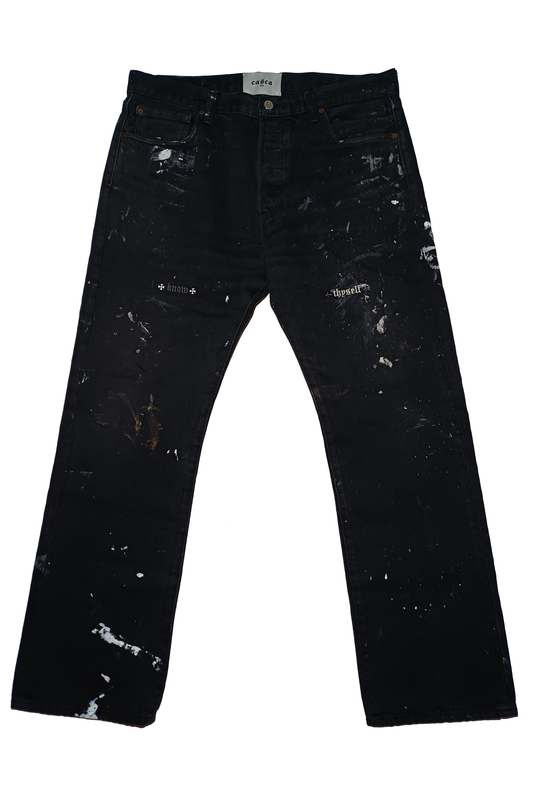 Front of black levi 501 distressed with paint splatter, know thyself embroidery, casca 222 woven label and leather label. 34 waist 30 length. Gallery Dept. Chrome Hearts. 
