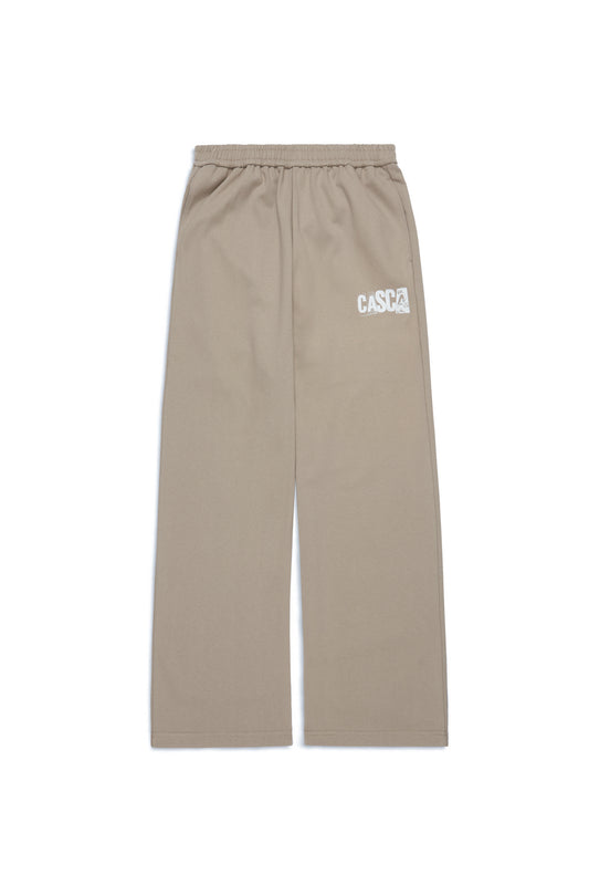 Beige straight leg baggy sweatpants with a casca 222 logo on a white background